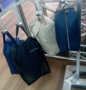 The navy blue bag on the right is a classic men's toiletry or wash bag.